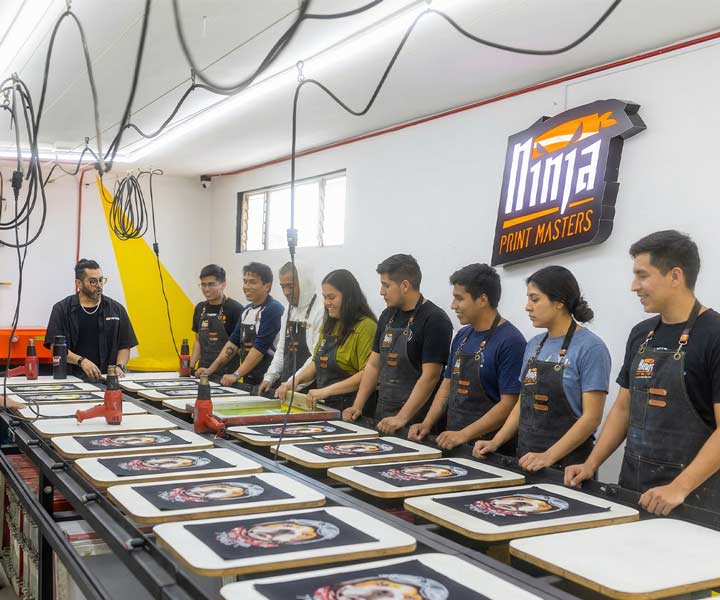 alumnos tomando curso presencial de serigrafia en mesa lineal CDMX